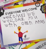 Kids drawing of a person saying 'welcome'